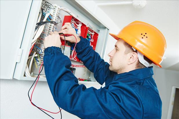 electrical and electronics installer working on a wiring system