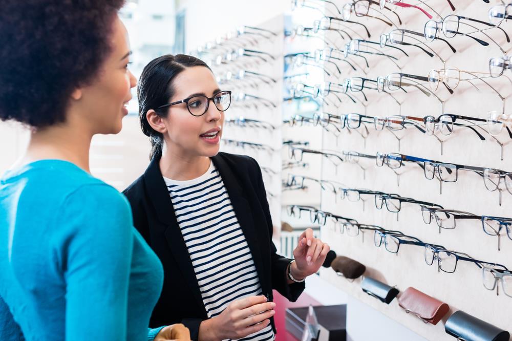 optician assisting a customer with selecting frames