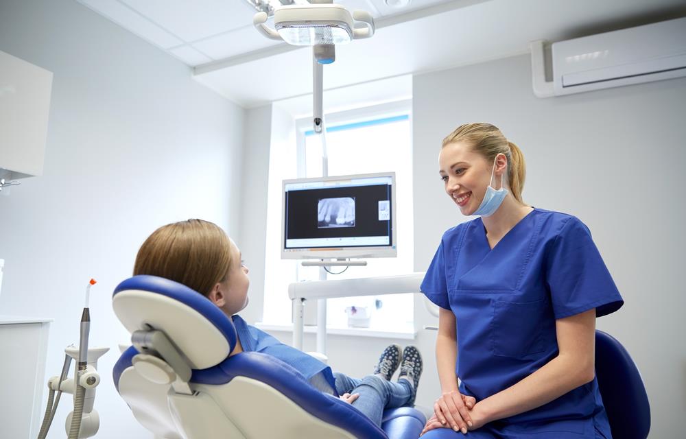 dental professional speaking with a patient