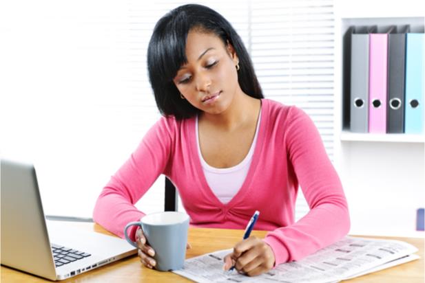 woman writing at a desk at work