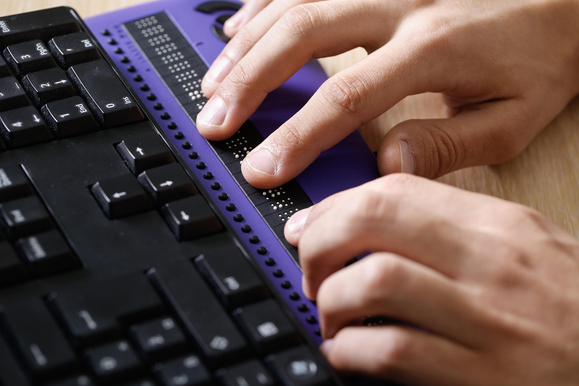 Person using a braille keyboard