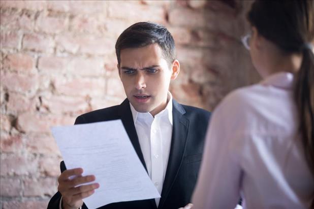 Unhappy manager reviewing work of bad hire