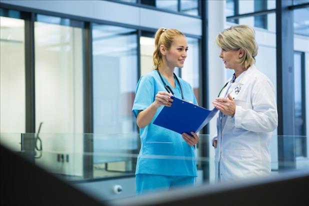 nurse practitioner discussing patient records with a physician