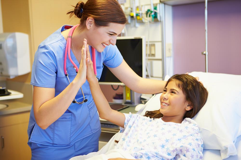 pediatric nurse practitioner giving her patient a high five 