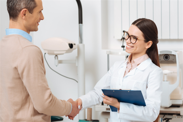 Practice owner shaking hands with newly hired associate optometrist
