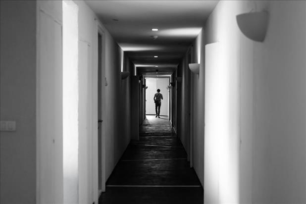 Ghostly apparition at the end of a long hallway