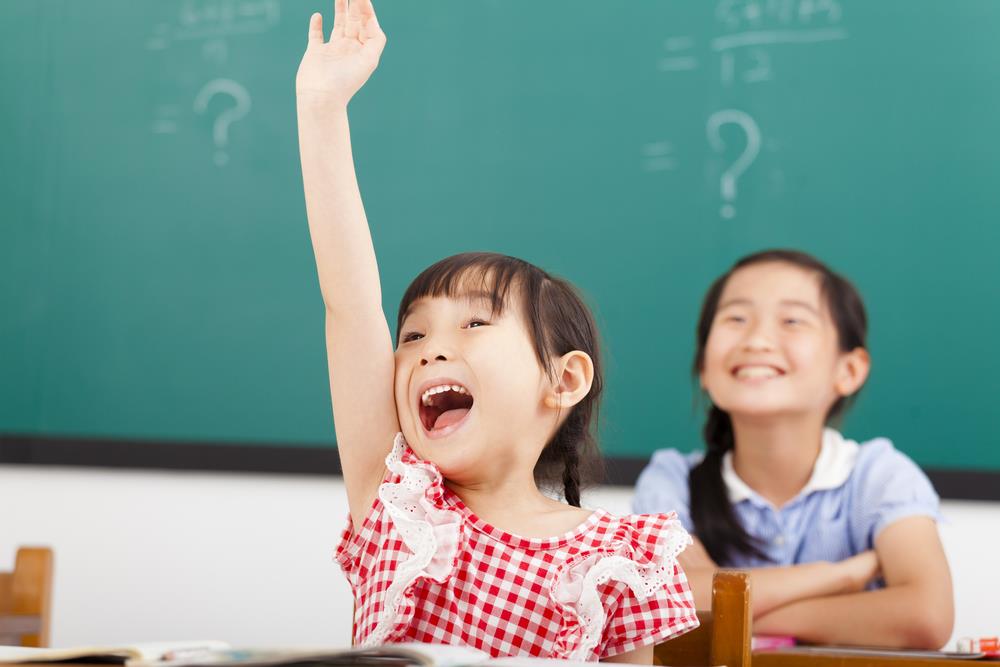 eager student raising her hand to ask a question