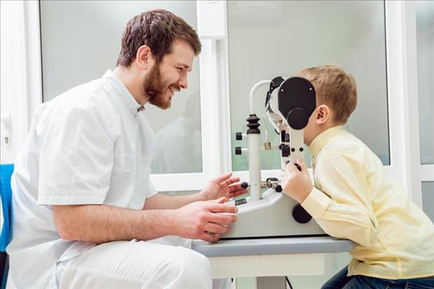 orthoptist running eye tests on a young male patient
