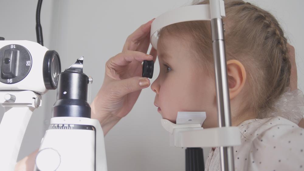 orthoptist checking a little girl's vision