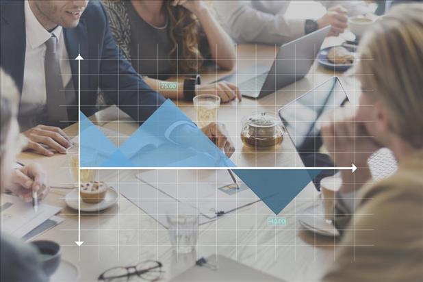 Group of professionals at conference table with graph superimposed over image