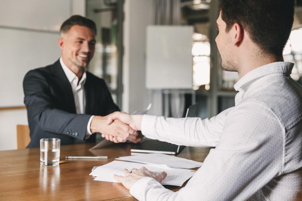 male job seeker shaking his interviewer's hand after the interview