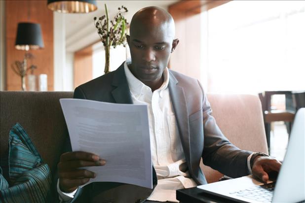 Business man reading resume at desk