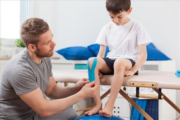 physical therapist with a pediatric patient