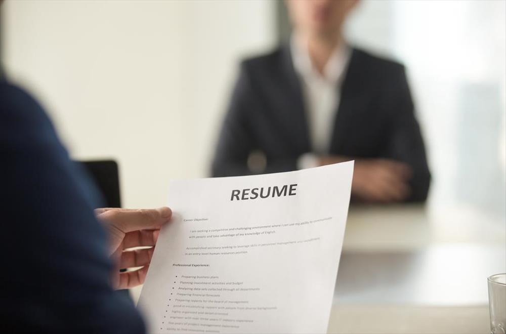 Person holding resume during interview