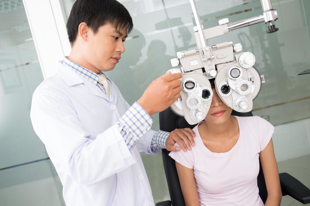 optometrist conducting an eye test on a young patient