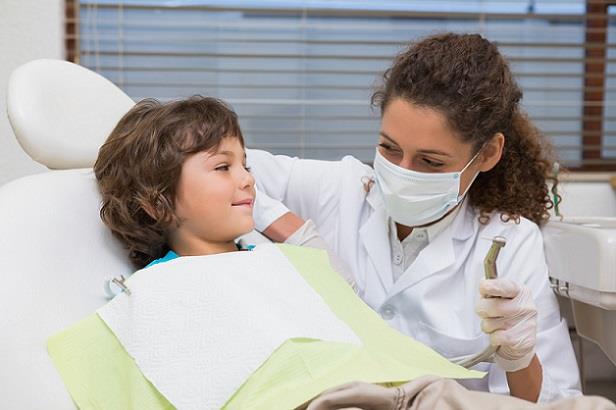 Pediatric dentist putting young patient at ease