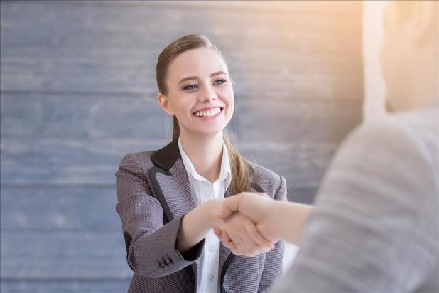 job seeker shaking hands with her interviewer