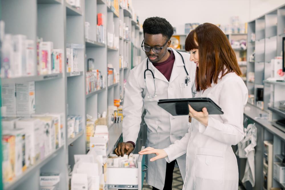 two pharmacists working together to fill prescription orders