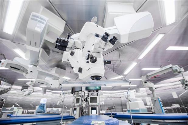 Training facility for ophthalmology students with large microscope over examination table