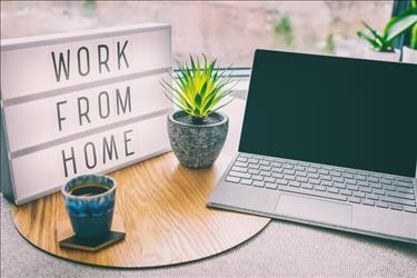 laptop on desk with work from home sign