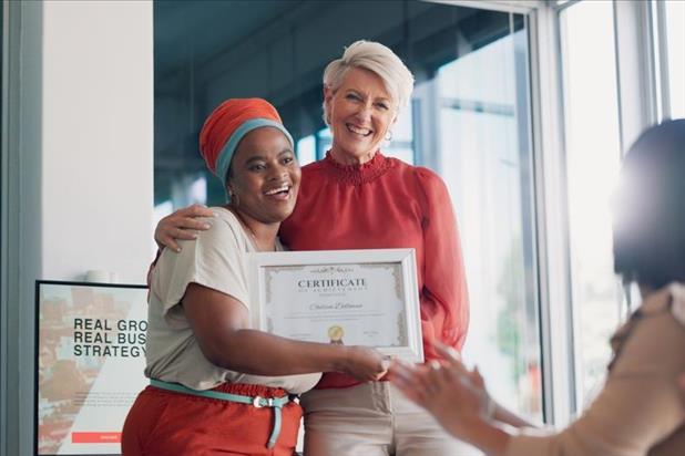 happy employee receiving a certificate from her manager