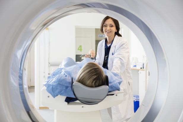 radiologist with patient in MRI machine
