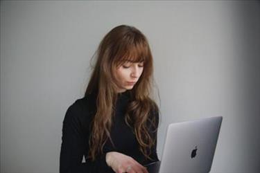 frustrated job seeker looking at her laptop after not getting the job