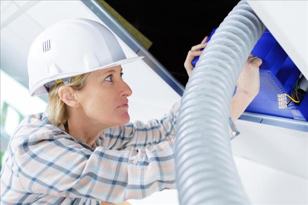 woman hvac/r professional fitting ventilation system