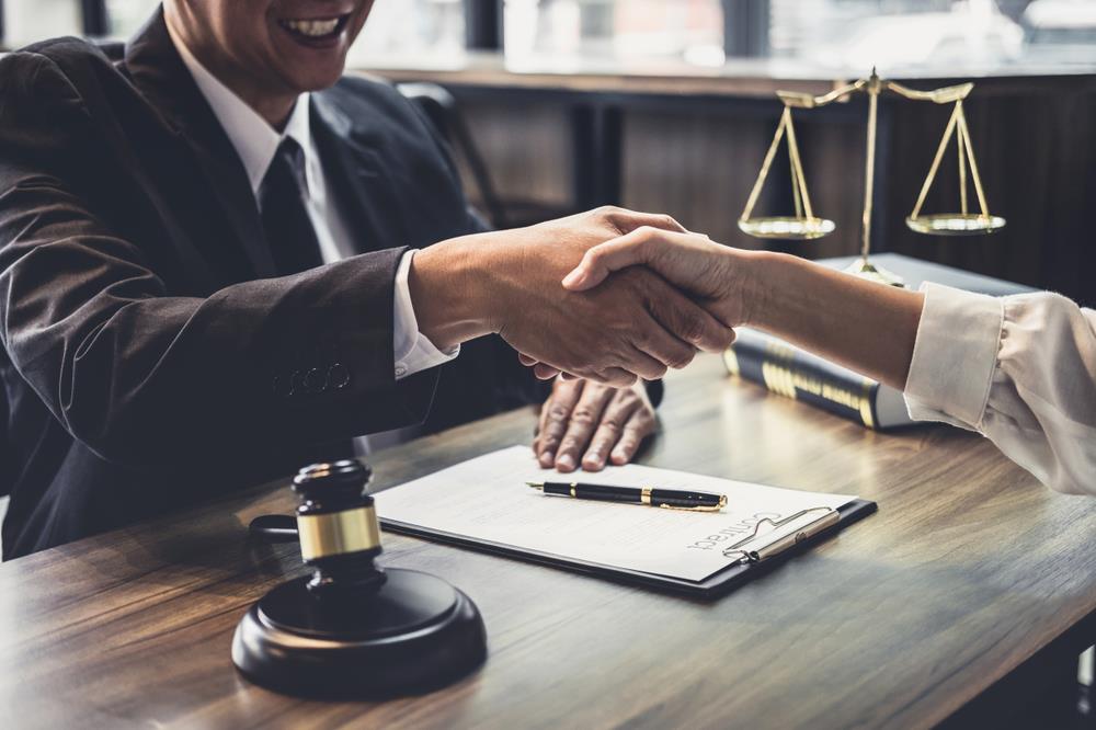 hiring manager shaking hands with a potential new legal hire