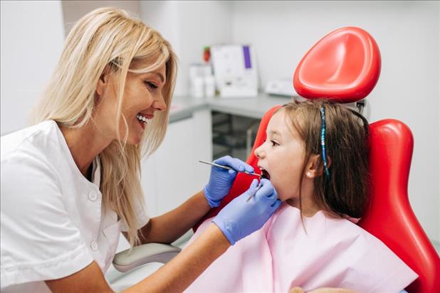 Dental hygienist with young patient