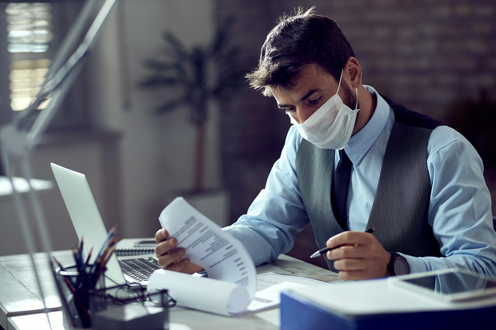 Person in an office wearing a mask while working