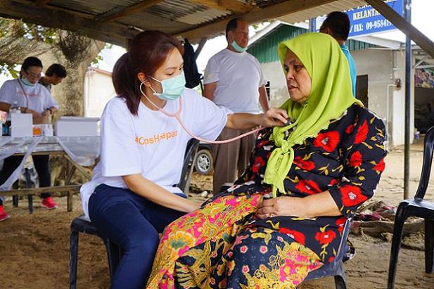 Volunteer nurse examining a patient in a rural village