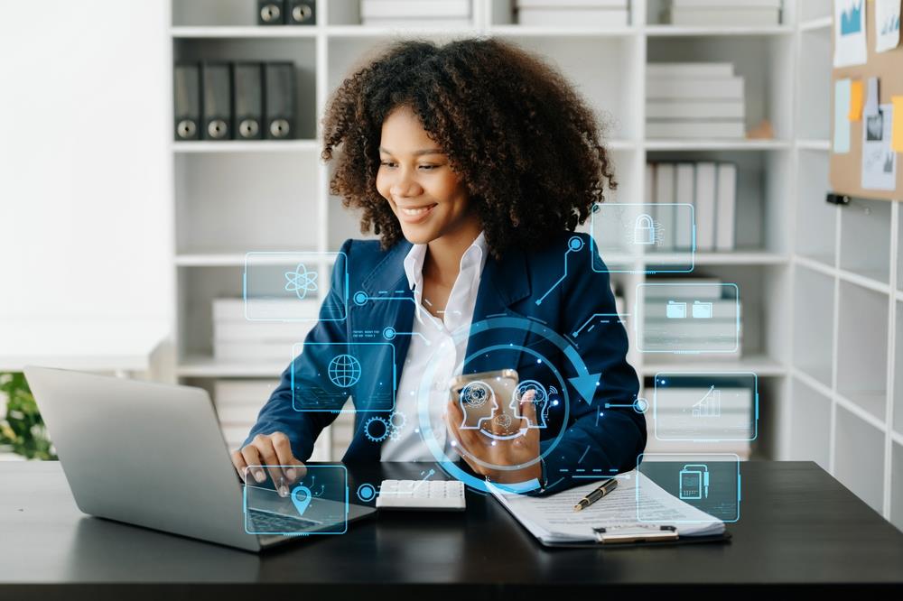 woman working on her laptop with tech related images surrounding her
