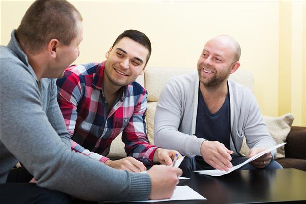 male social worker meeting with two clients