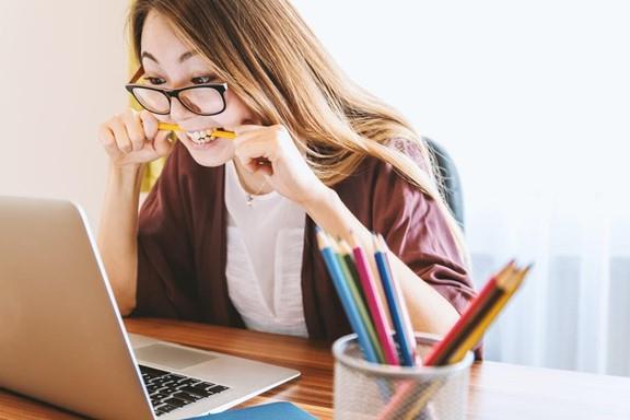 job seeker biting on her pencil out of anxiety