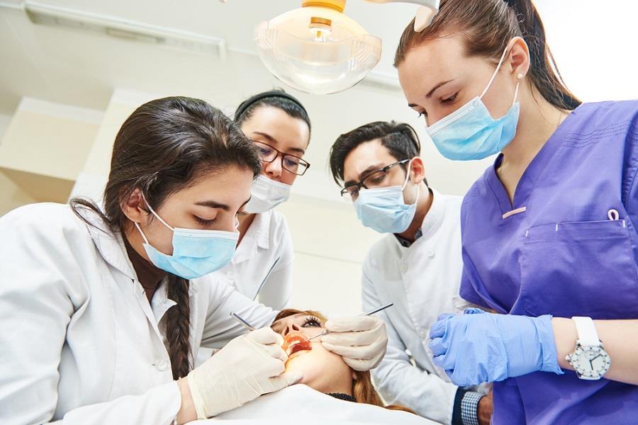 allied dental educator teaching group of students