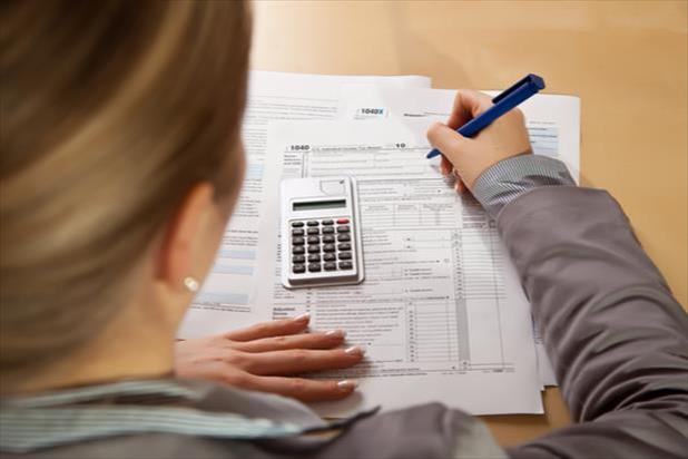 woman filling out tax forms
