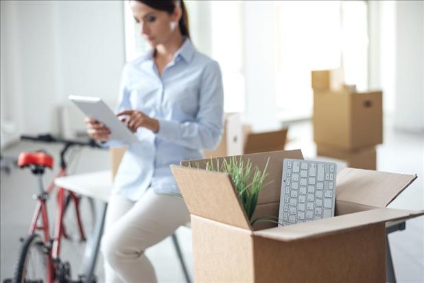 woman packing up her office to relocate to a new city